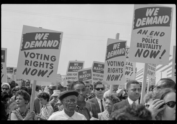 Marchers of many races, genders, and ages with signs at the March on Washington.