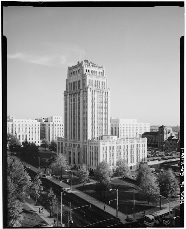 A marble and granite high-rise office building built in a Neo-Gothic style with distinct and elaborate details.