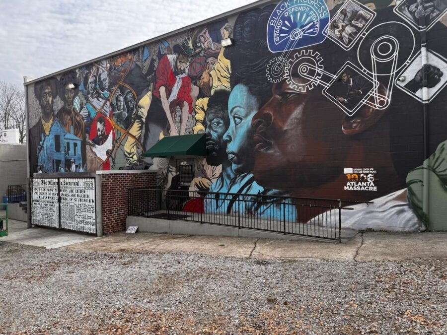 Photograph of an outdoor mural featuring images from the 1906 Atlanta Race Massacre.